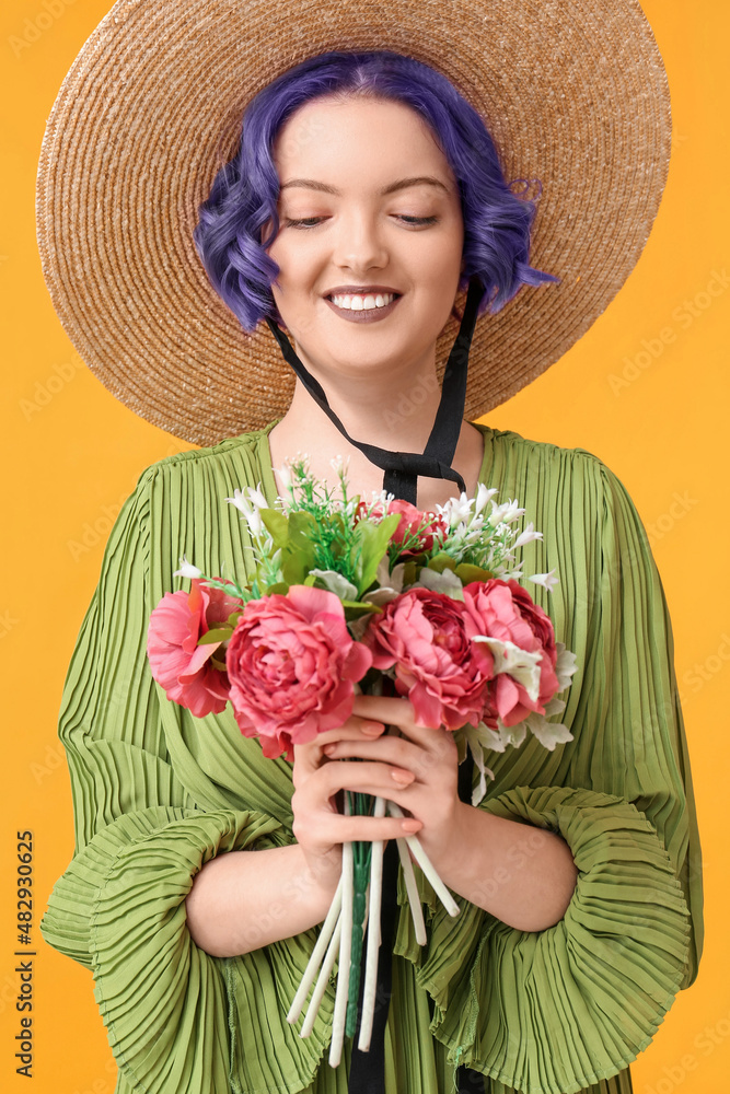 Beautiful young woman with violet hair and bouquet of flowers on yellow background. Very Peri - colo