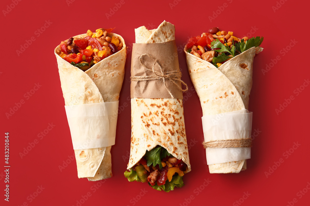 Delicious burritos on red background
