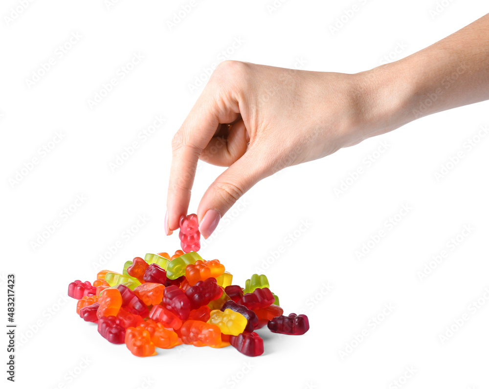 Woman eating tasty jelly bears on white background