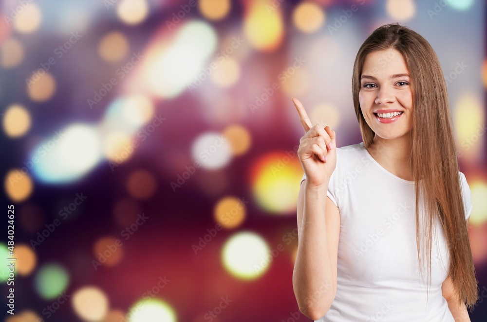 Happy young woman hand pointing up to copy space
