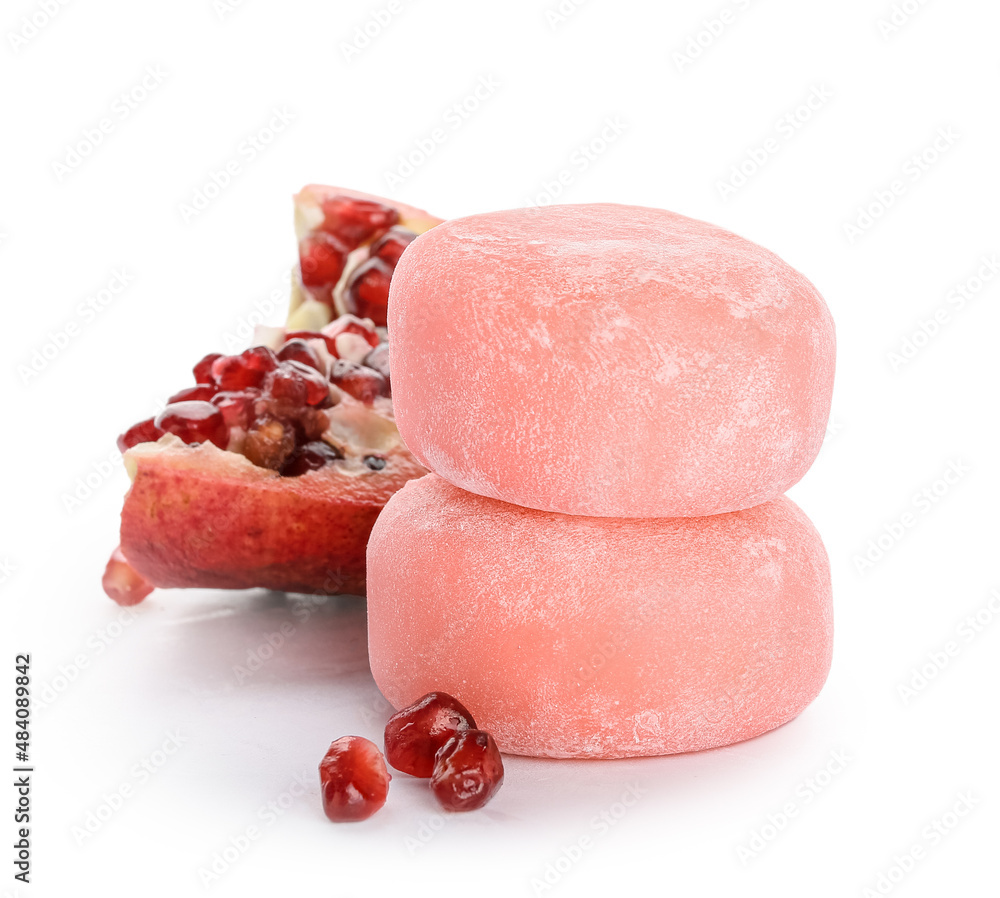 Delicious mochi and pomegranate on white background