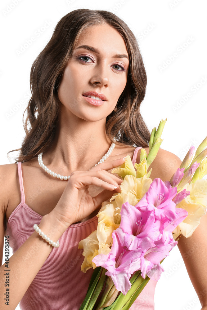 Woman with stylish jewelry holding bouquet of Gladiolus flowers on white background