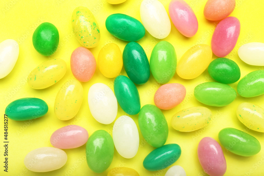 Multicolored jelly beans on color background