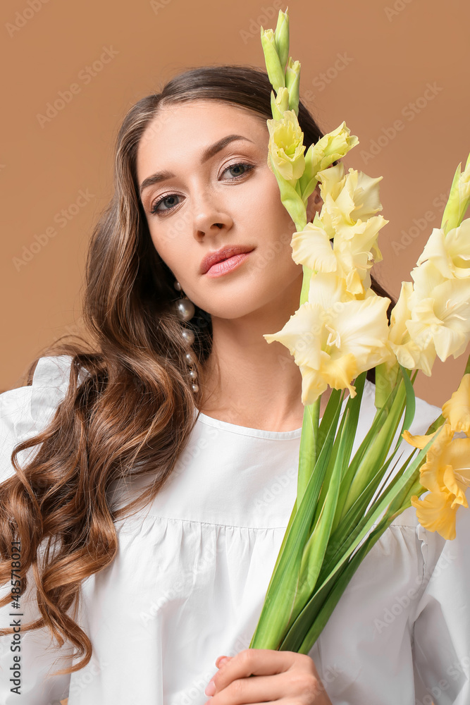 年轻时尚女性手持彩色背景的唐菖蒲花束