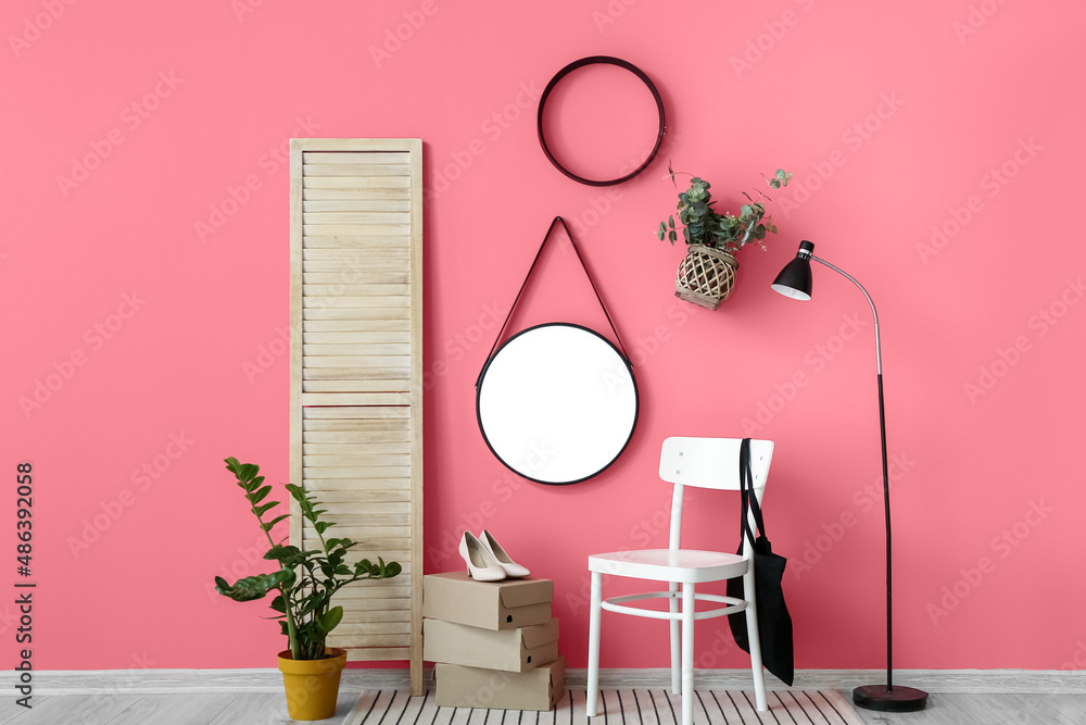 Stylish interior of modern hallway on pink wall background