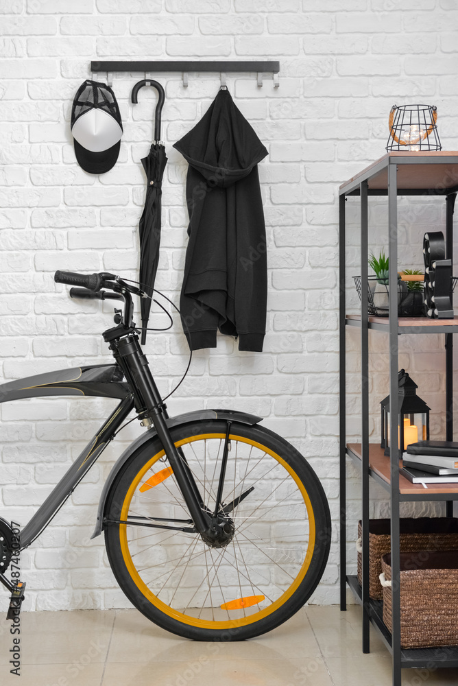 Stylish interior of room with  modern bicycle and light brick wall