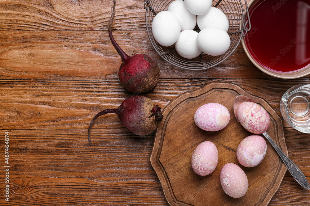 复活节彩蛋、甜菜和木制背景上的自制天然染料碗