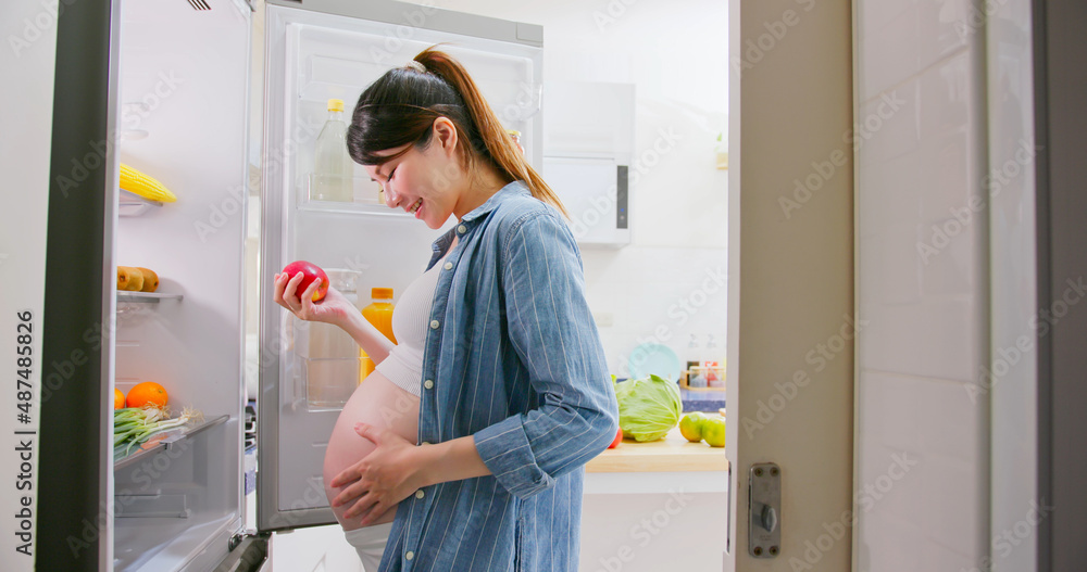 Asian pregnant woman prepare fruit
