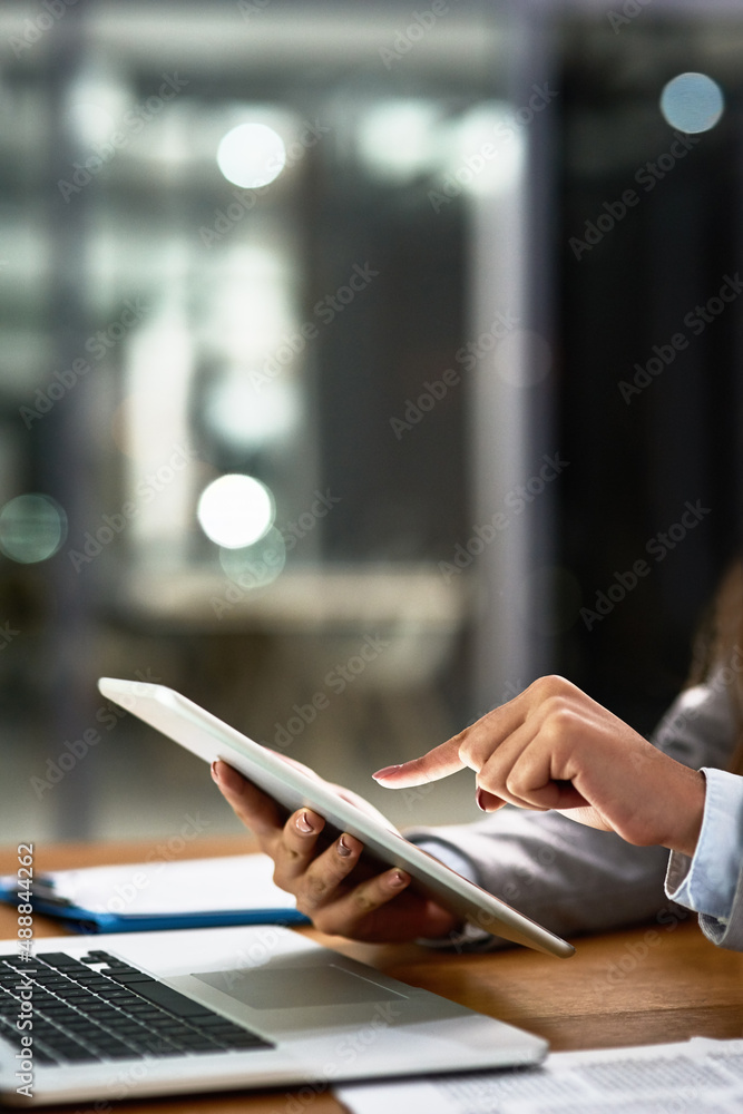 Work smarter, work better. Cropped shot of a businesswoman using a digital tablet and laptop at her 
