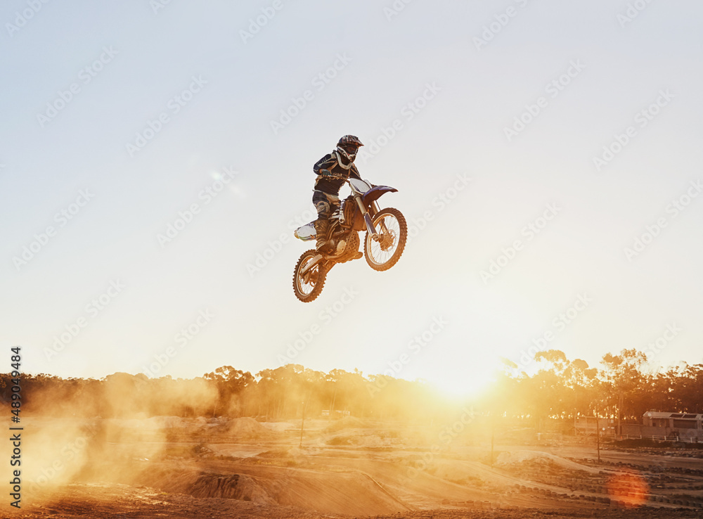 Hes flying through the air. A shot of a motocross rider in midair during a race.