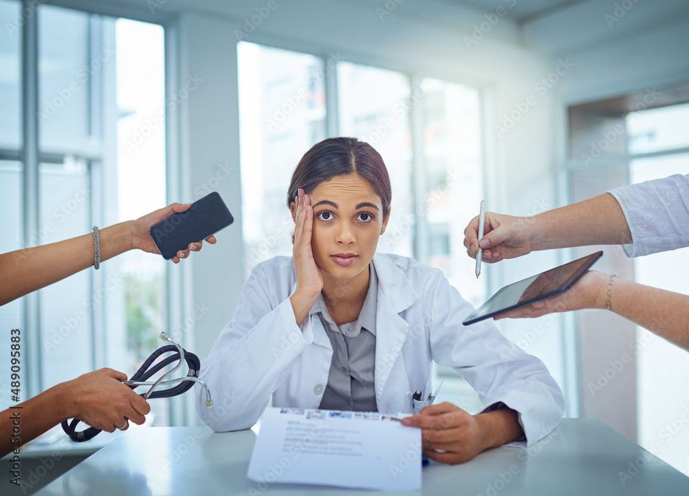 Its too chaotic to cope. Portrait of a young female doctor looking stressed out in a demanding work 