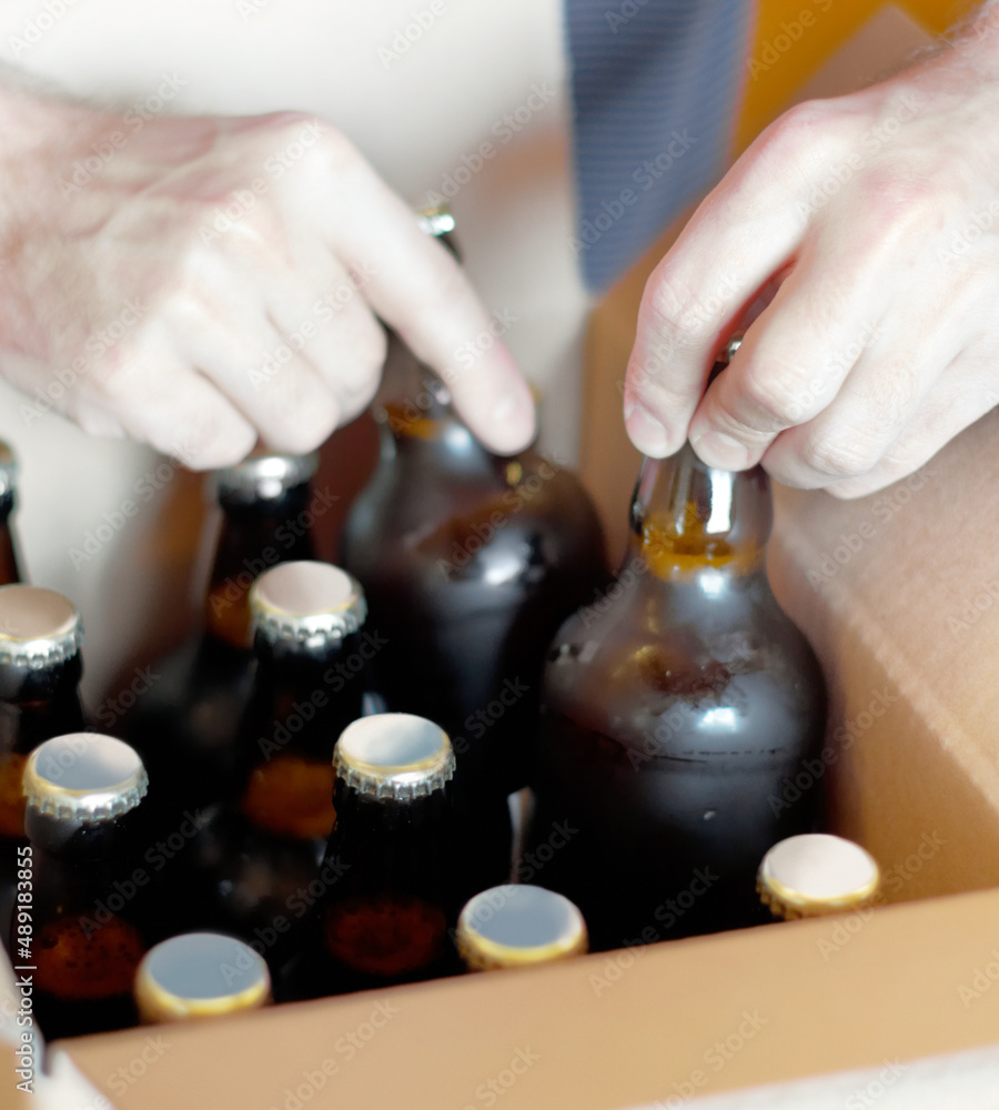Lets get these boys ready for a party. Shot of bottled beer being boxed for distribution.