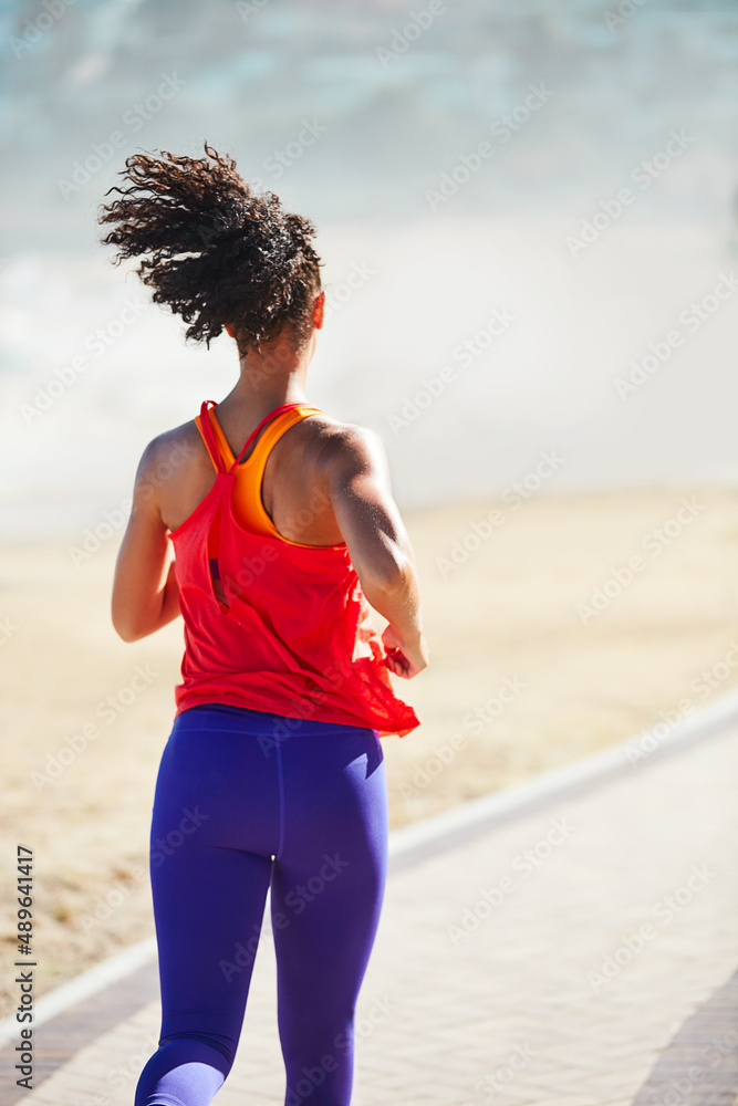 Youre always closer than you were yesterday. Shot of a sporty young woman out for her morning run.