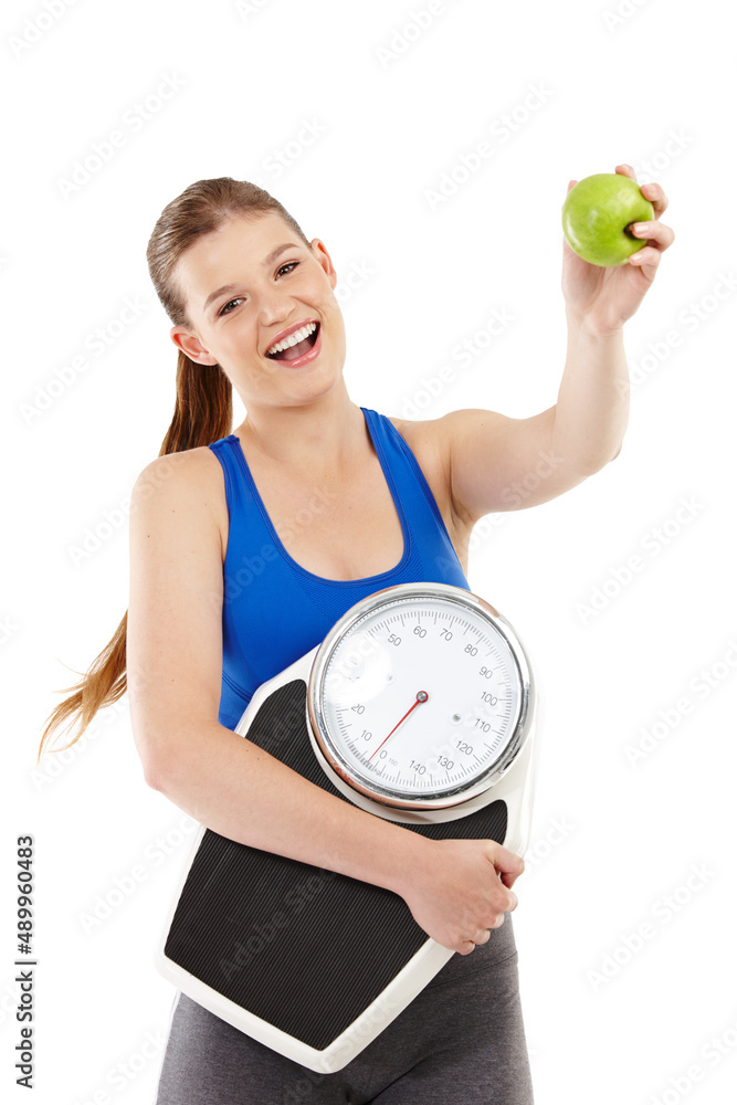 Advocating a healthy lifestyle. A pretty teenager holding an apple in her hand while carrying a scal