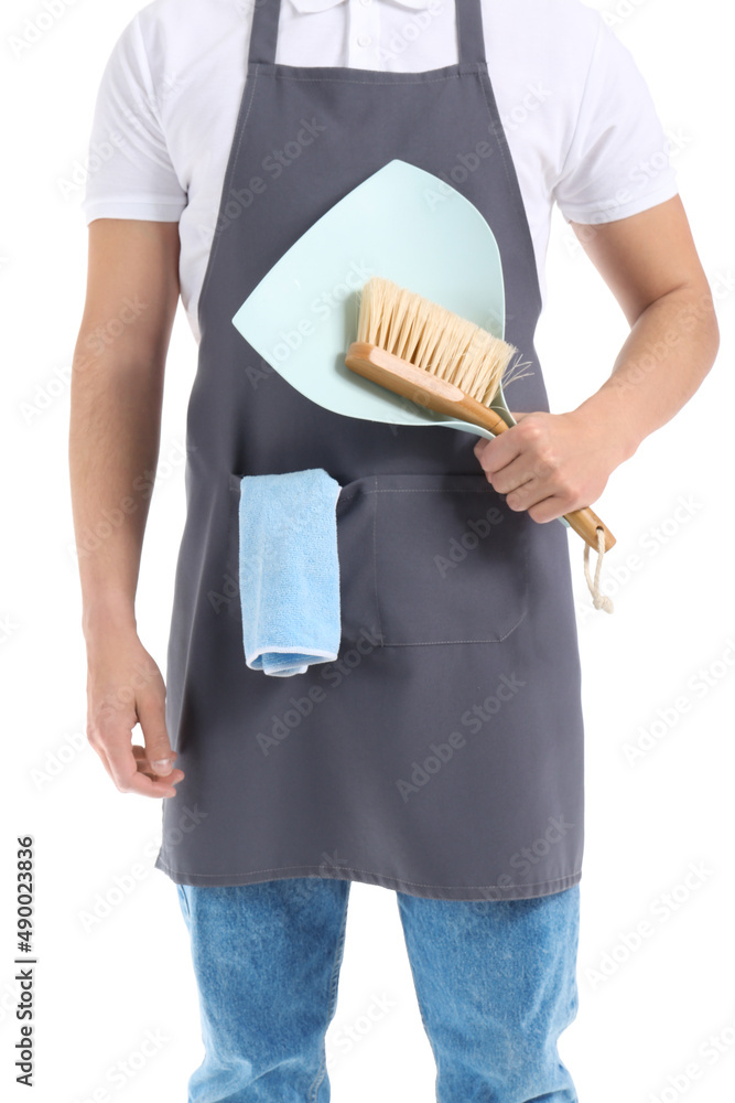 Young male worker of cleaning service with dustpan and brush on white background