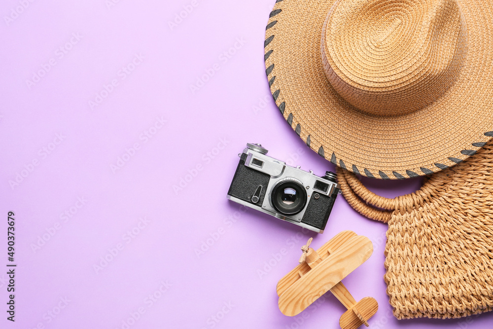 时尚的帽子、包包、相机和彩色背景木平面