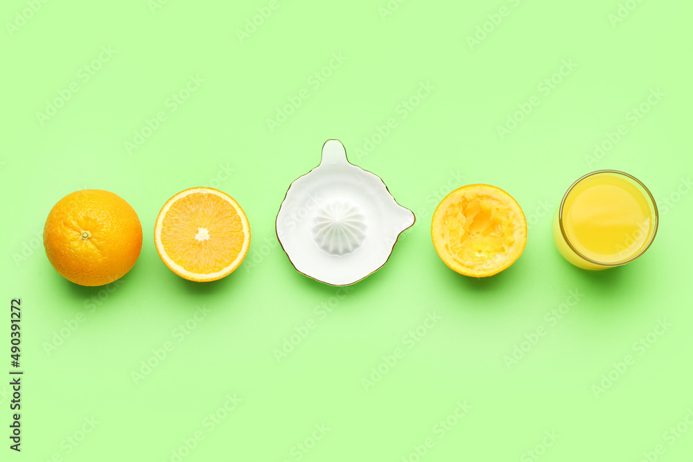 陶瓷榨汁机，一杯绿色背景的果汁和橙子