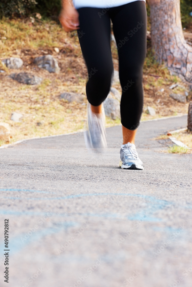 女性慢跑。女性在小路上慢跑的低段。