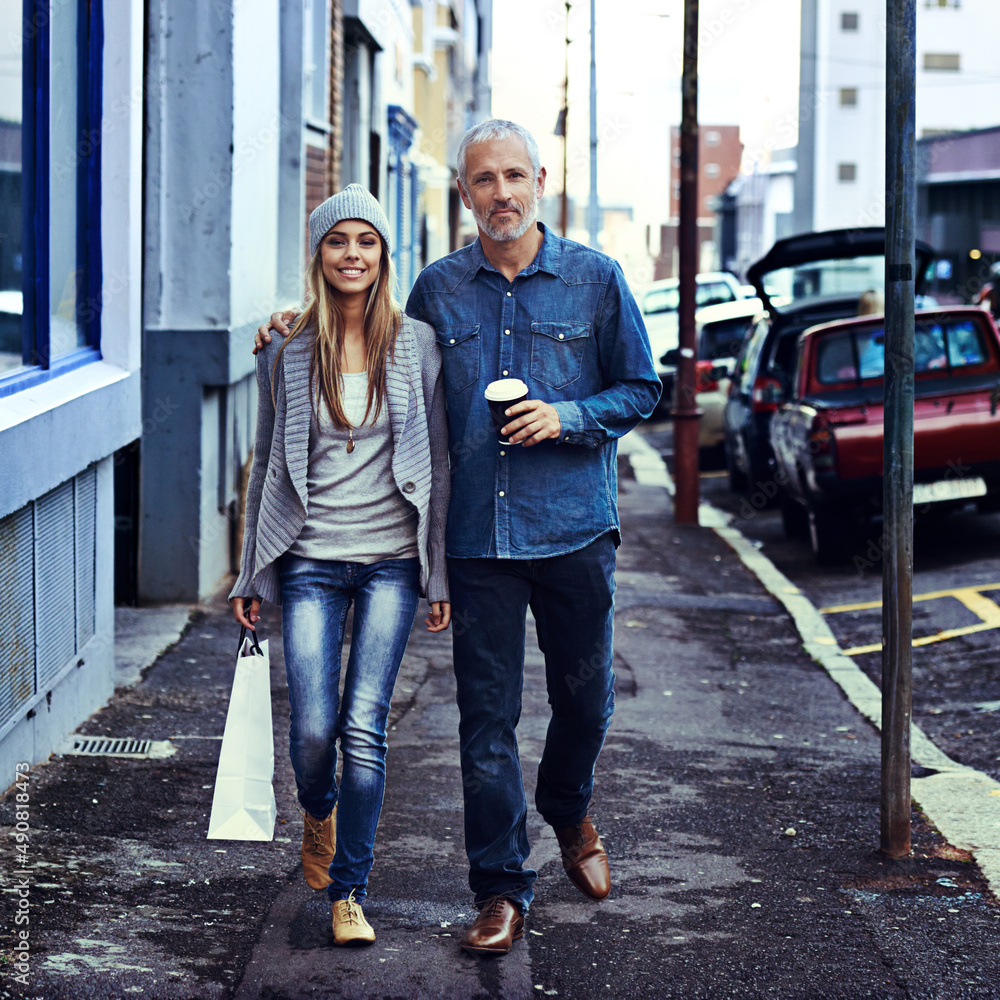 They decided to hit town today. Portrait of a father and daughter walking together in the city with 