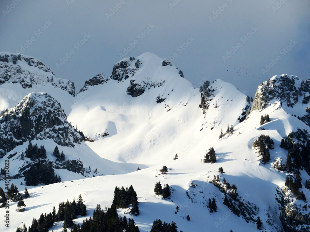 Snow-covered high alpine pastures and rocky peaks of the Alpstein massif in winter attire (Appenzell