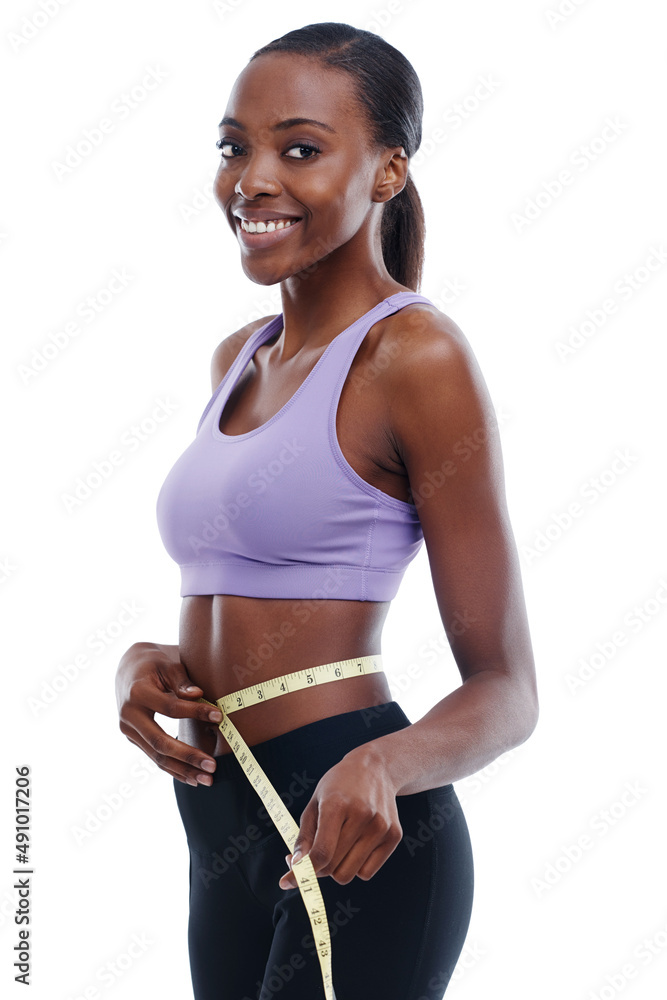 Nothing feels better than reaching your goals. An isolated portrait of a sporty young woman measurin