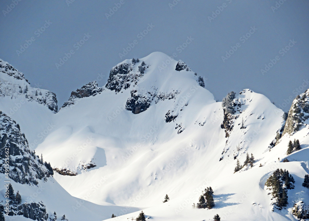 Snow-capped alpine peak Schwarzchopf (1949 m) in Alpstein mountain range and in Appenzell Alps massi