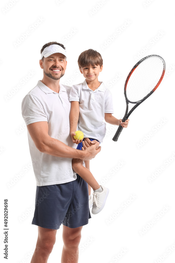 小男孩和他的父亲拿着网球拍和白底球