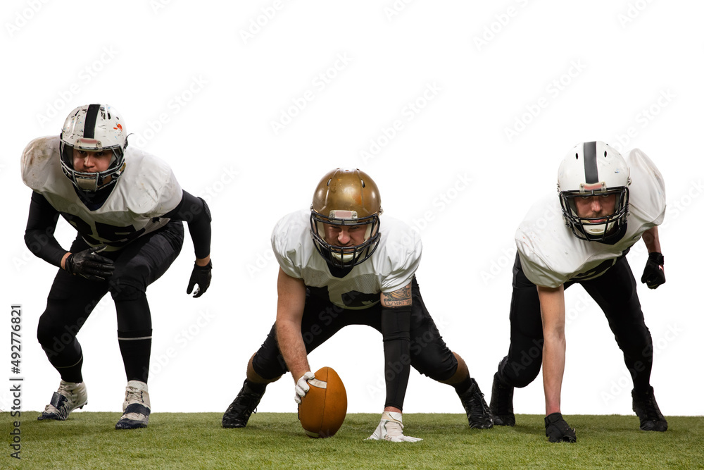 Three young sportive men, professional american football players in sports uniform and equipment in 