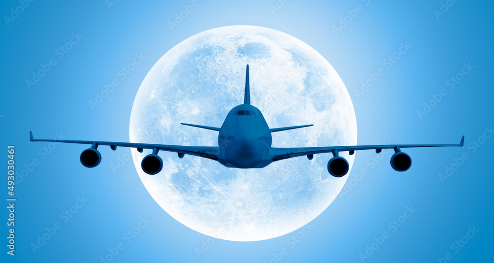 Large passenger airplane in the sky at night full moon in the background - Travel by airtransport El