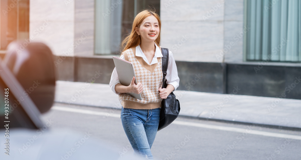 Young Asian woman going to work