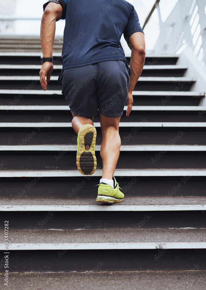 Building his stamina with some stair sprints. Cropped shot of a sporty young man running up steps.