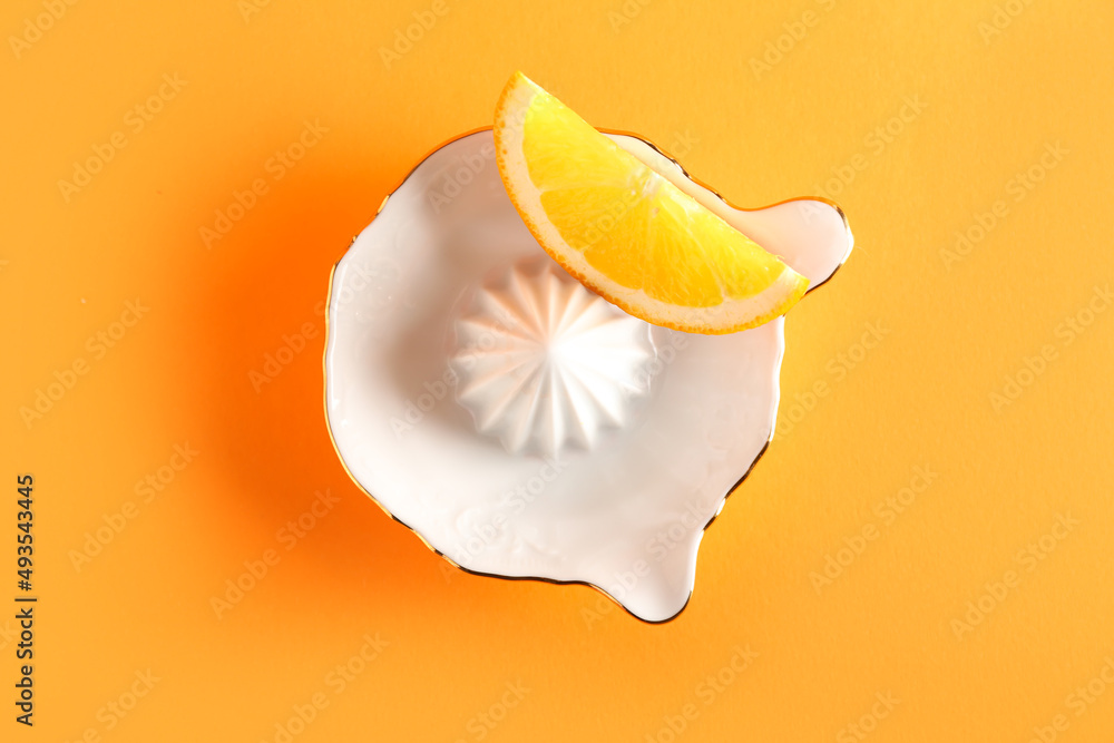 Ceramic juicer and orange on orange background