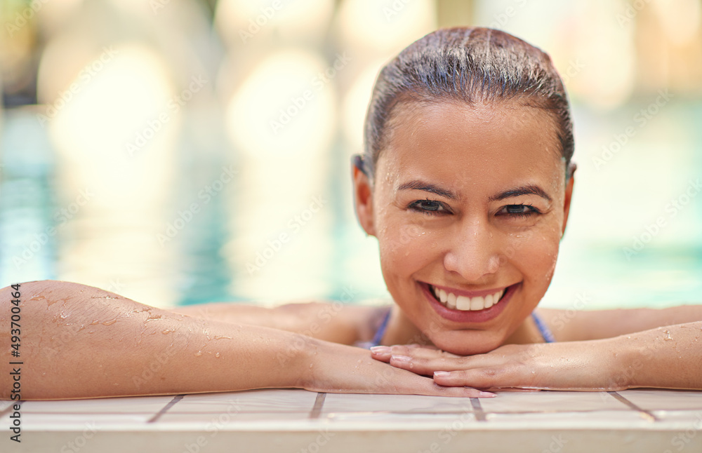 Youre only one swim away from a good mood. Shot of a young woman relaxing in the pool at a spa.