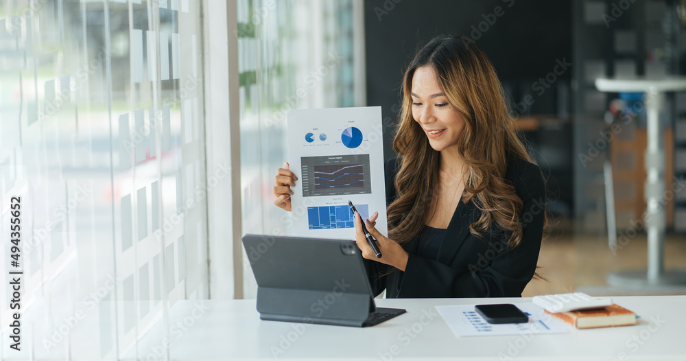 Focused business woman presenting charts and graphs on video call online. Young business woman havin