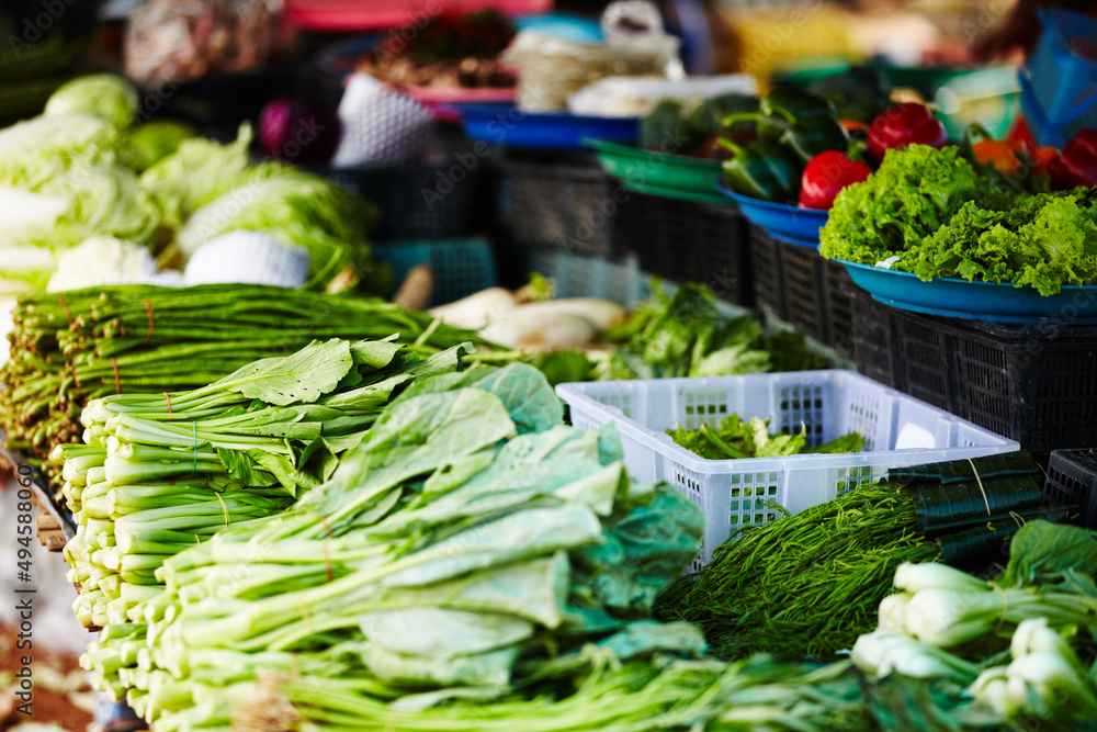Local Thai vegetable stall. A stall in a Thai fresh food market packed with fresh, green vegetables.