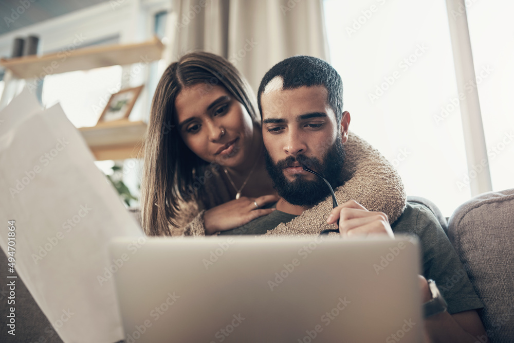 将预算时间变成亲密时间。一对年轻夫妇在经历时使用笔记本电脑的镜头