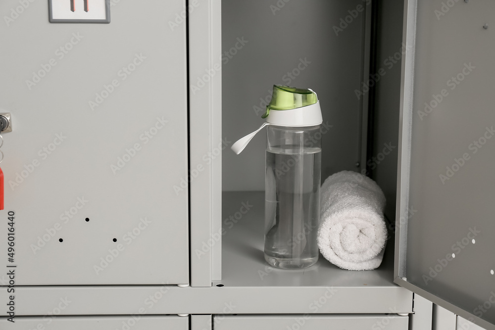 Bottle of water and towel in locker