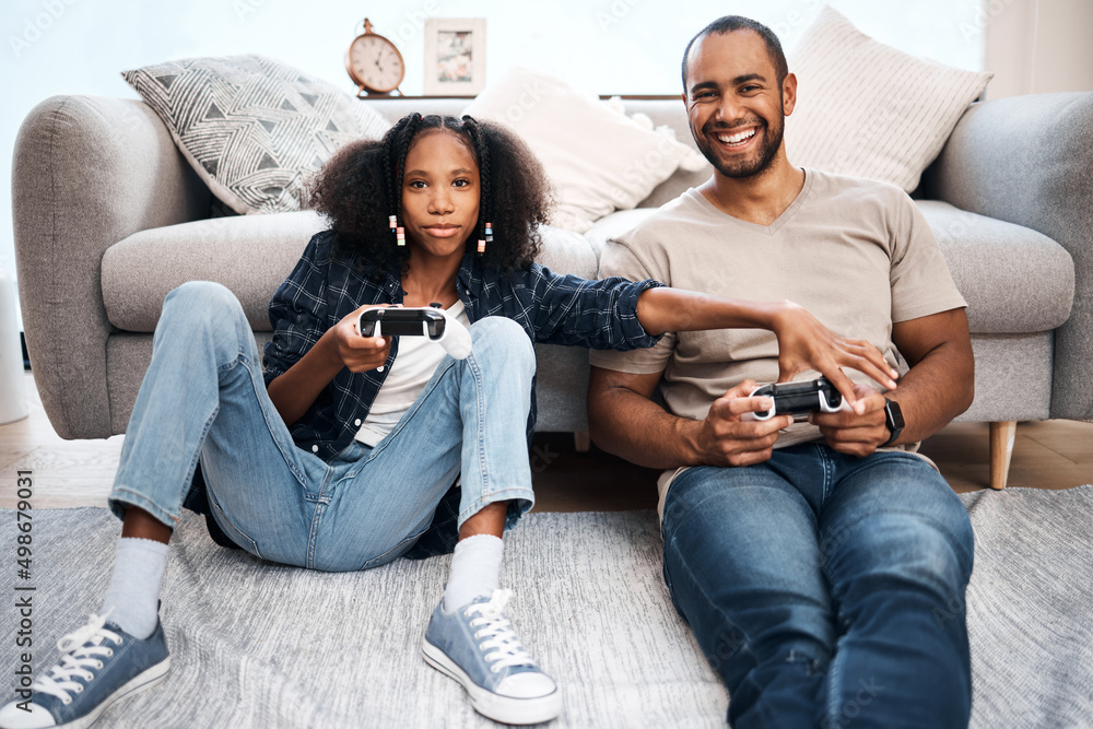 Quality time takes a relationship to the next level. Shot of a young girl playing video games with h