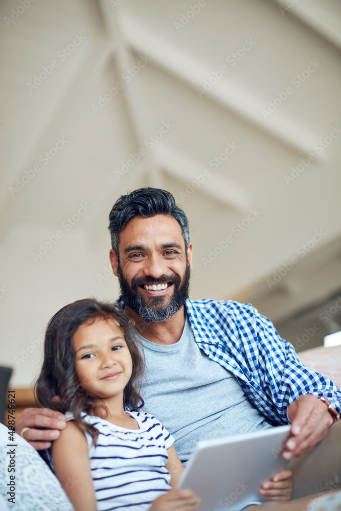 Theres so much to learn and discover online. Portrait of a father and daughter using a digital table