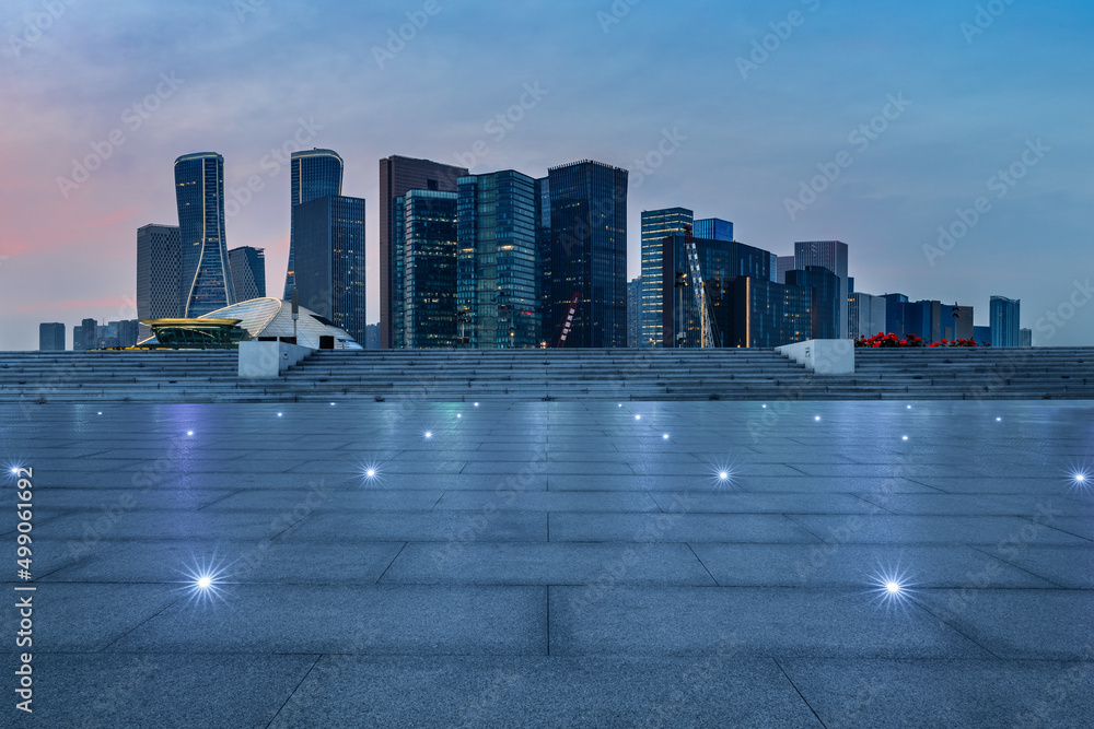 中国杭州夜晚空旷的广场和城市天际线，现代商业建筑。