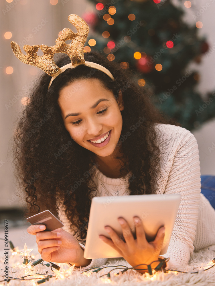 一直到发薪日。一个快乐的年轻女人在圣诞节期间用笔记本电脑和信用卡的镜头