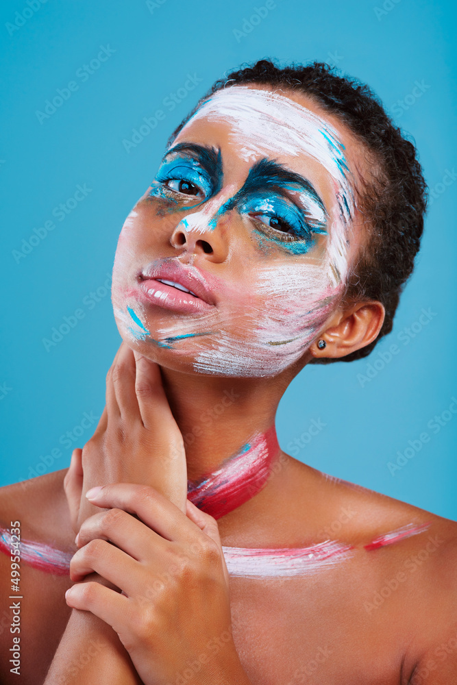 Sometimes youve just gotta stand out. Studio portrait of a beautiful young woman covered in face pai