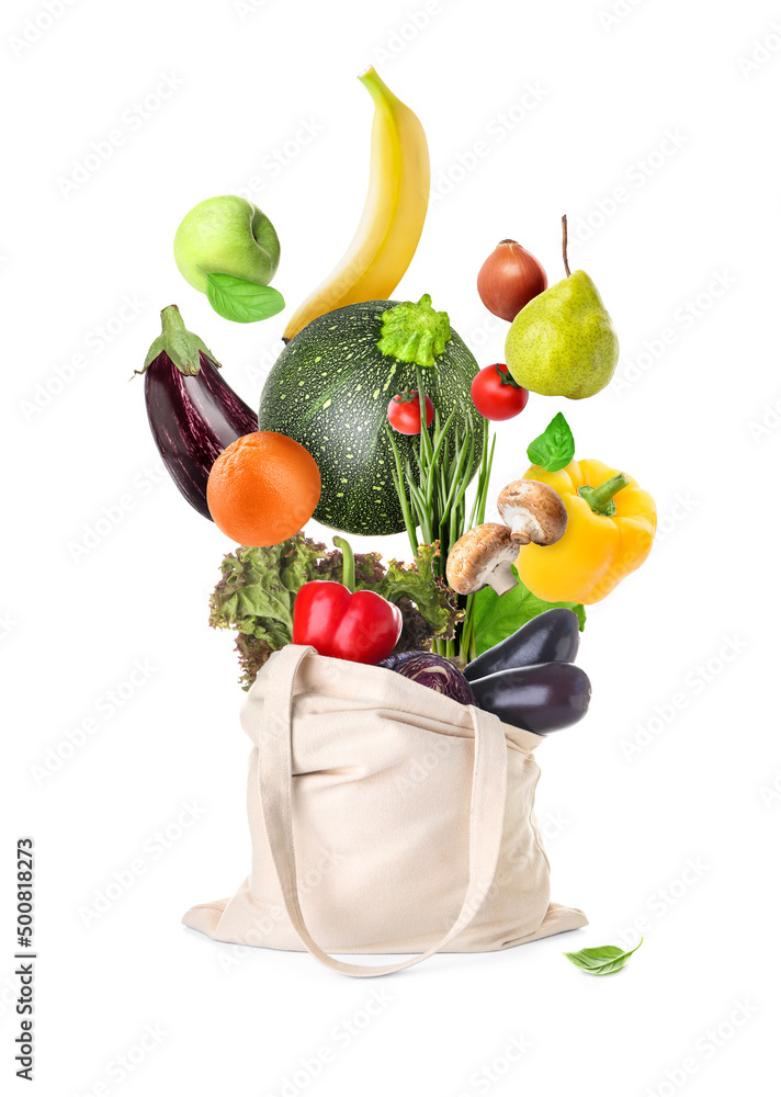 Shopping bag with flying fresh vegetables and fruits on white background