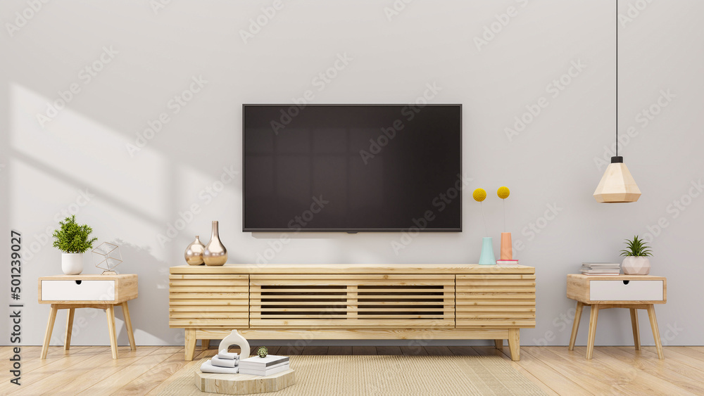 现代客厅橱柜上的电视，客厅里的植物，白色的空墙。