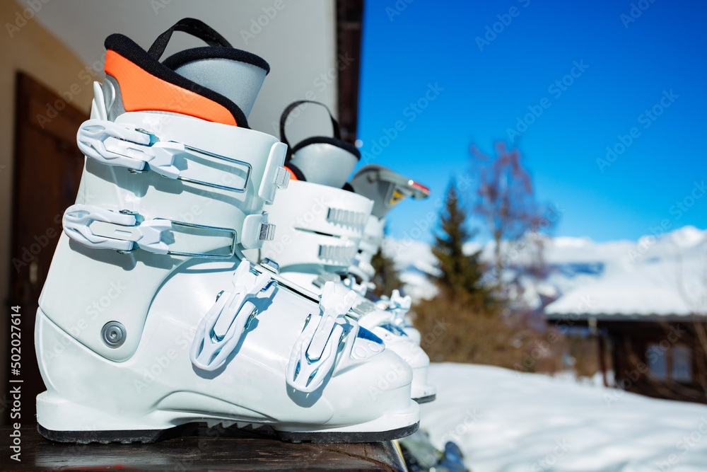 Close-up of alpine ski boots on balcony rail -vacation concept