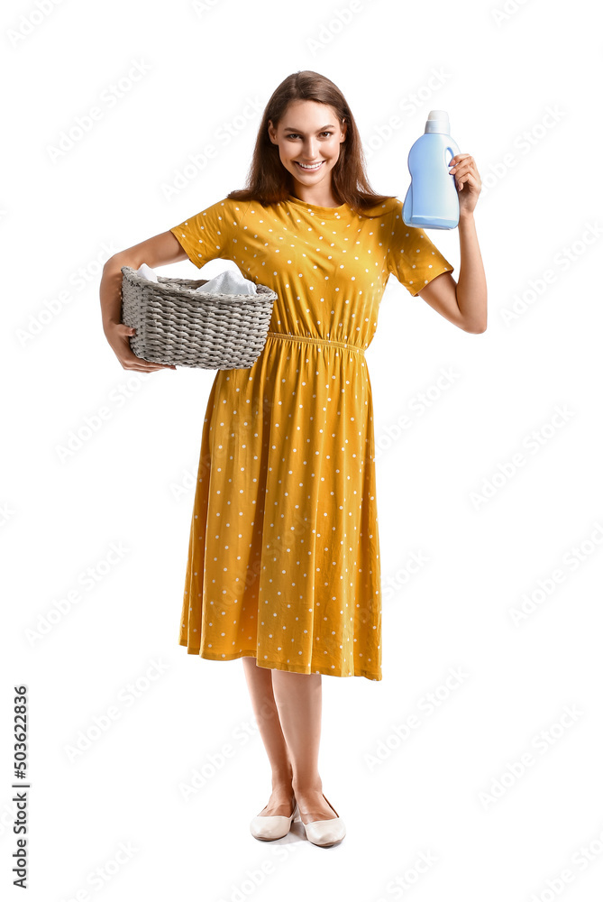 Beautiful housewife with laundry and detergent on white background