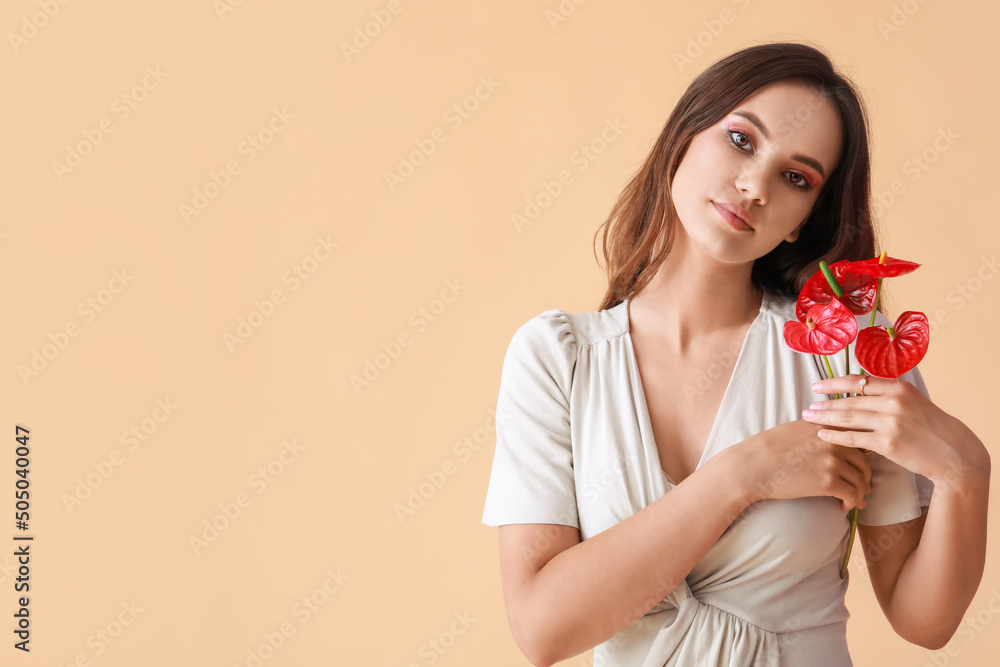 Portrait of fashionable woman with bouquet of beautiful anthurium flowers on color background