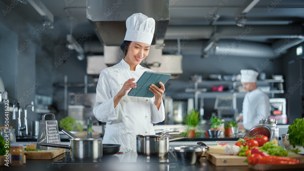 世界著名餐厅：亚洲女厨师烹饪美味正宗的食物，使用数字平板电脑