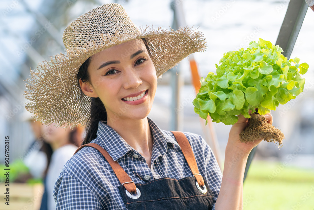 Portrait of beautiful girl farmer working in vegetable hydroponic farm	
