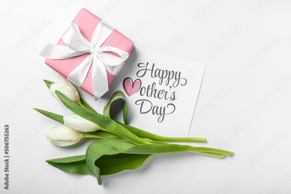 Card with text HAPPY MOTHERS DAY, tulips and gift box on white background